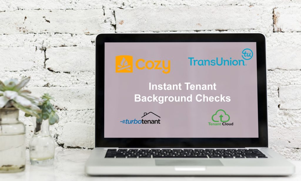 Instant tenant background check service provider logos on a laptop screen