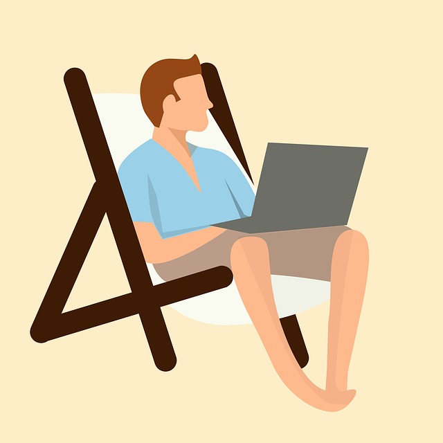 man relaxing and working on a computer at the beach because his real estate syndication deals are more passive thatn landlording